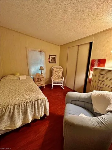 Bedroom featuring a textured ceiling and a closet