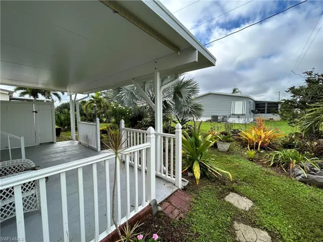 View of yard featuring cooling unit and a wooden deck