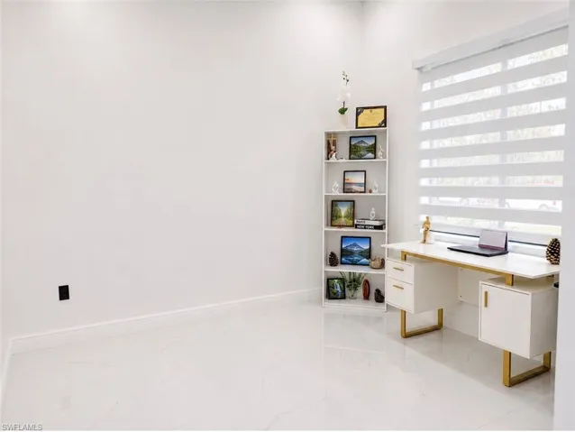 Bright interior space featuring light-toned flooring and white walls