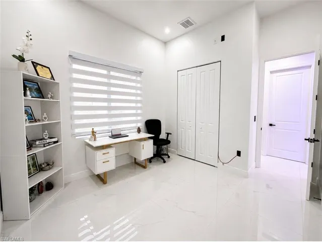 Bright room featuring light tile flooring and white walls