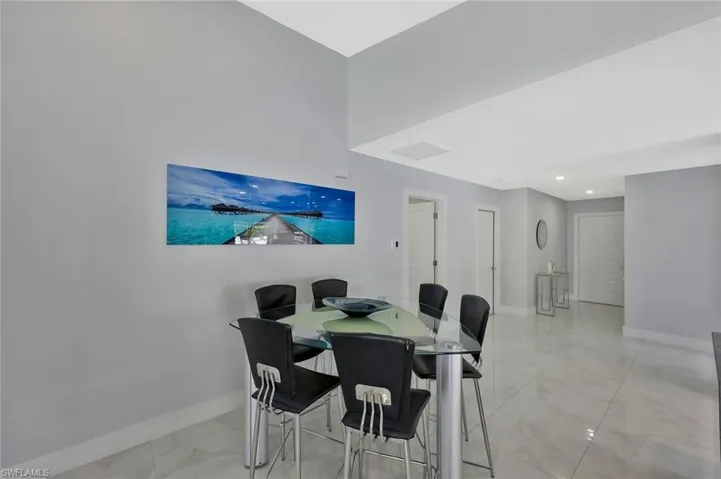 Dining space featuring light marble finish flooring and recessed lighting