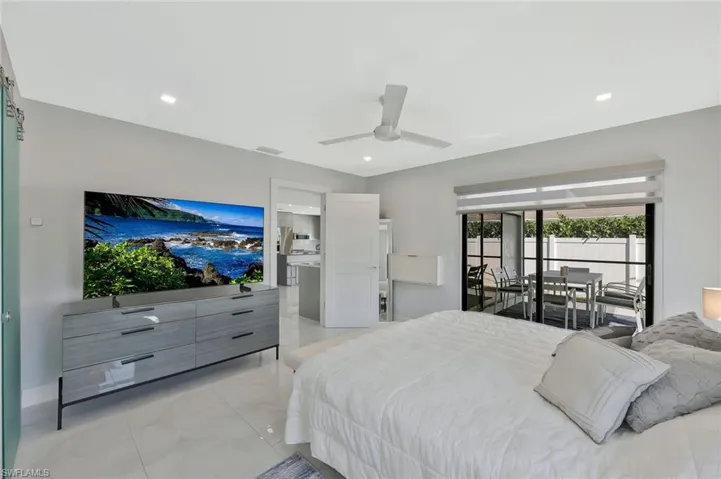 Bedroom featuring access to exterior, ceiling fan, recessed lighting, and light marble finish floors