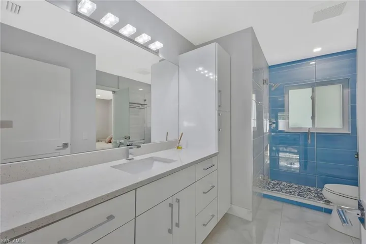 Bathroom with vanity and a shower stall
