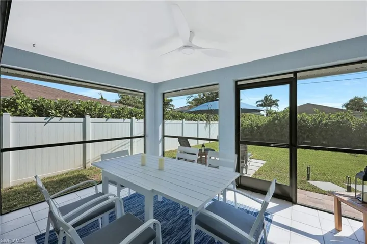Sunroom with a ceiling fan and outdoor dining area