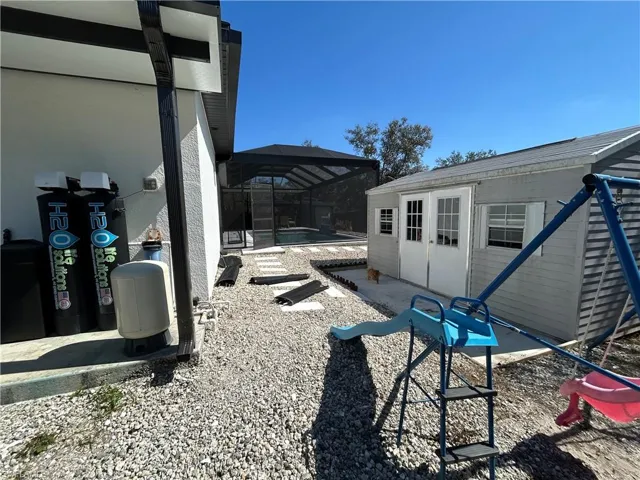 View of patio / terrace with a lanai, a pool, and a sunroom