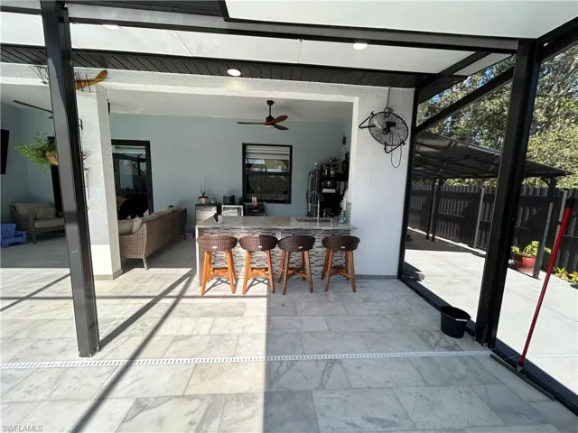 Sunroom / solarium featuring a patio and a ceiling fan