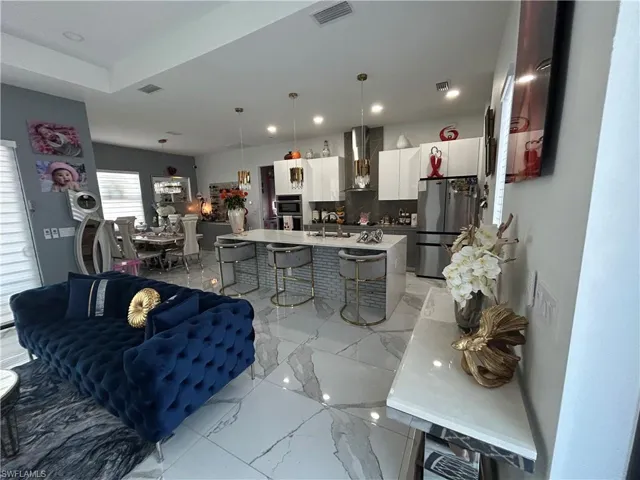 Living room with light marble finish flooring and recessed lighting