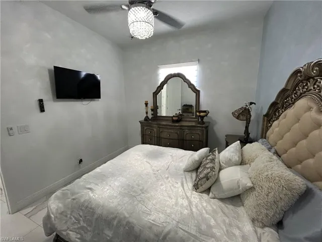 Bedroom featuring baseboards and ceiling fan
