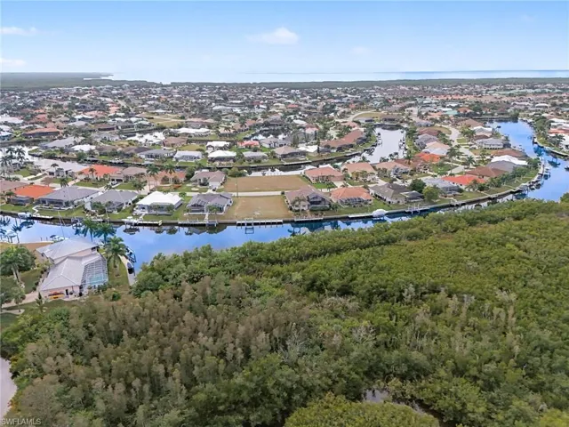 View of property location with a nearby body of water and nearby suburban area