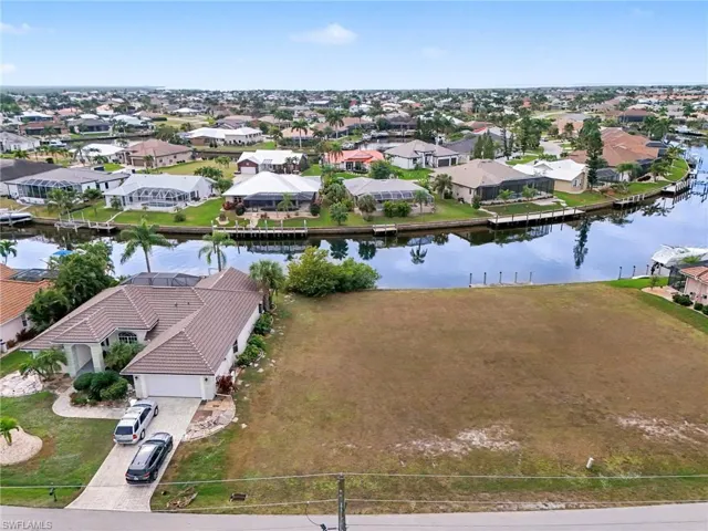Aerial perspective of suburban area featuring a nearby body of water