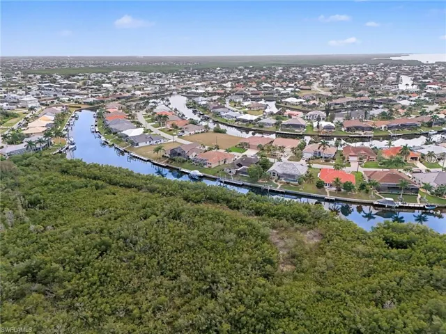 Aerial overview of property's location with a nearby body of water and nearby suburban area