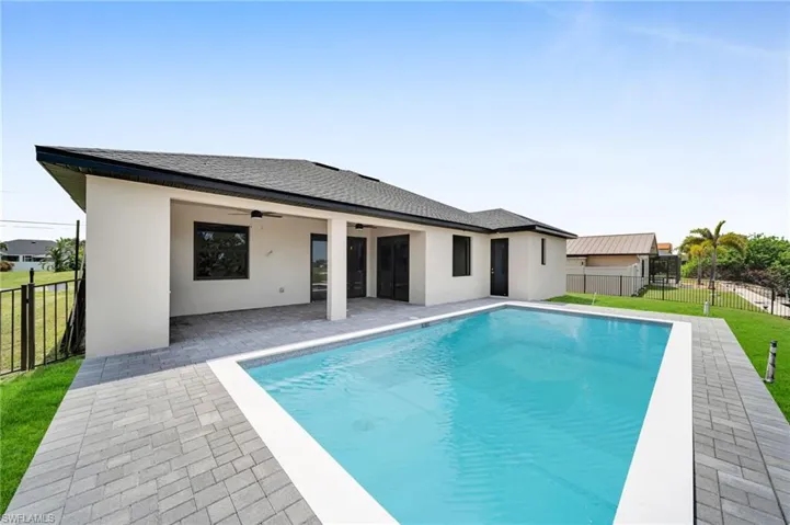 Back of house with a ceiling fan, stucco siding, a fenced backyard, a patio area, and a shingled roof