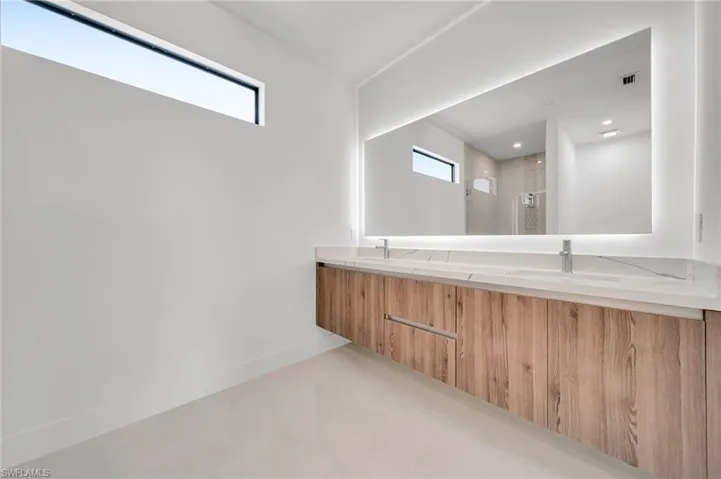 Bathroom with a stall shower and double vanity