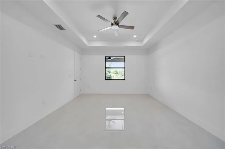 Spare room featuring ceiling fan, recessed lighting, and a raised ceiling