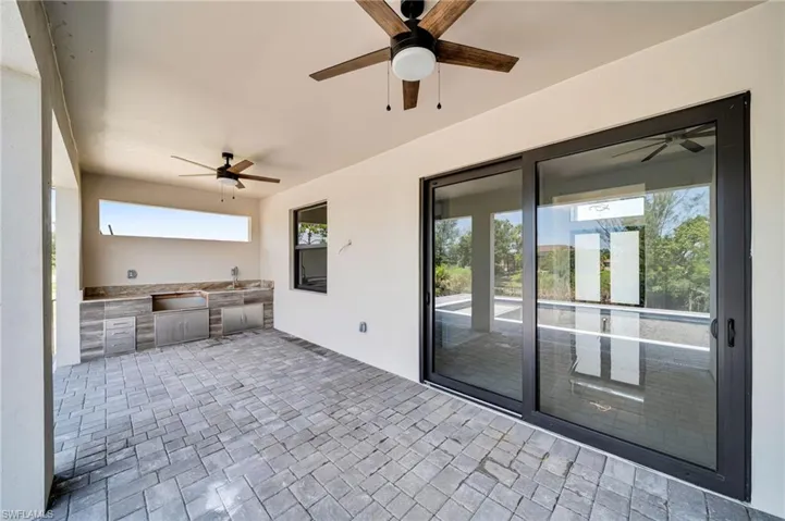 View of patio / terrace with a ceiling fan and exterior kitchen