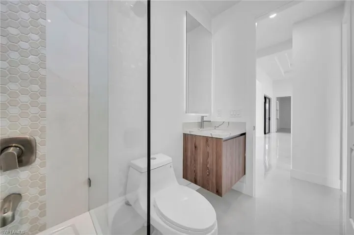 Full bathroom with vanity, a shower, recessed lighting, and tile patterned floors