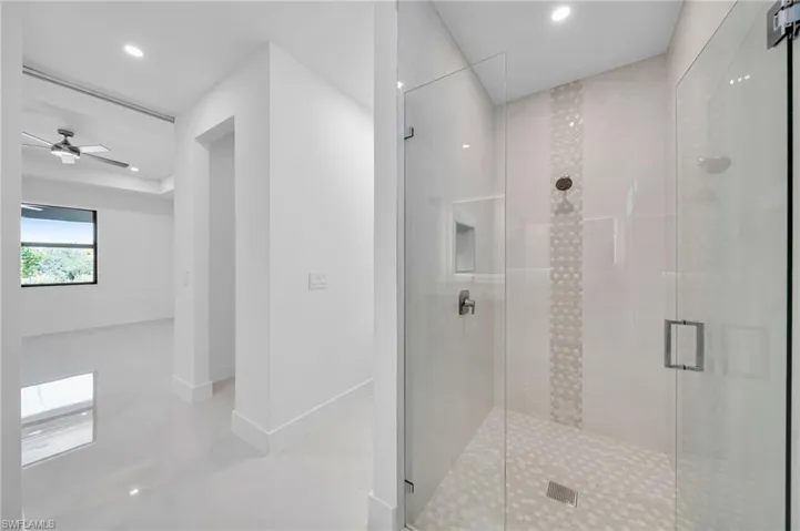 Full bath with a stall shower, recessed lighting, and a ceiling fan