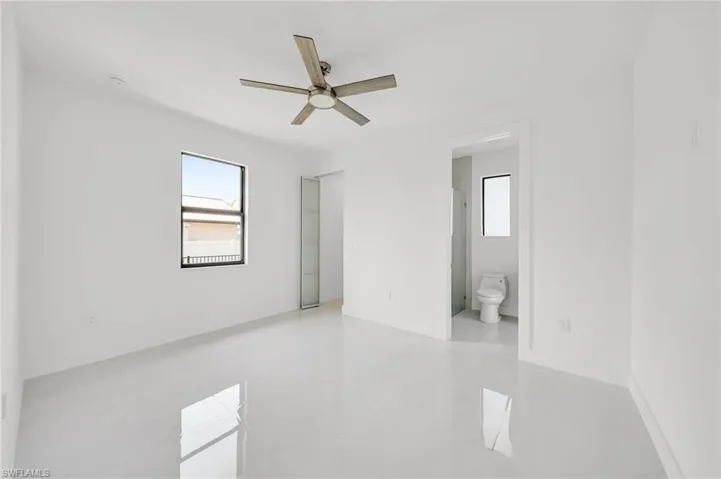 Spare room with a ceiling fan and light tile patterned floors