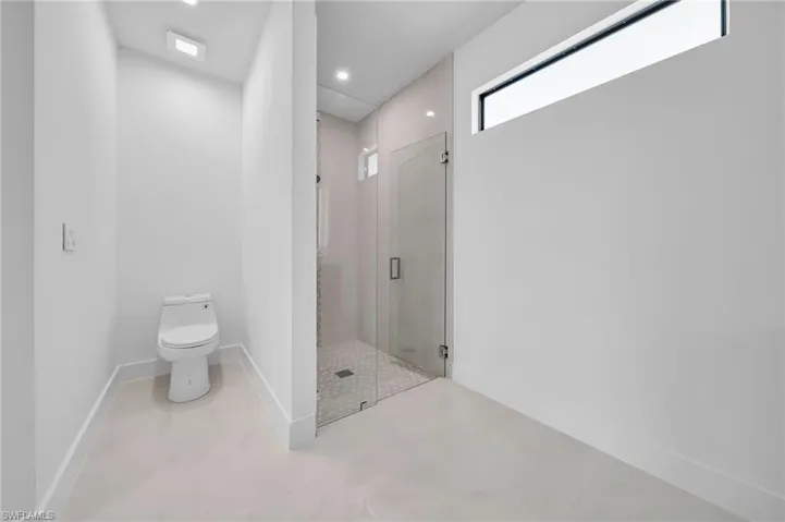 Full bathroom with a stall shower and recessed lighting
