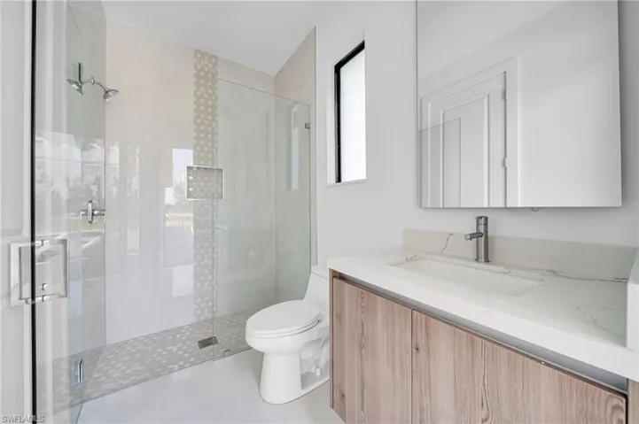 Bathroom with vanity and a stall shower