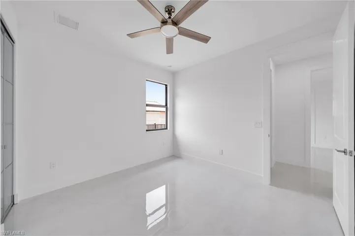 Unfurnished bedroom featuring a ceiling fan and baseboards