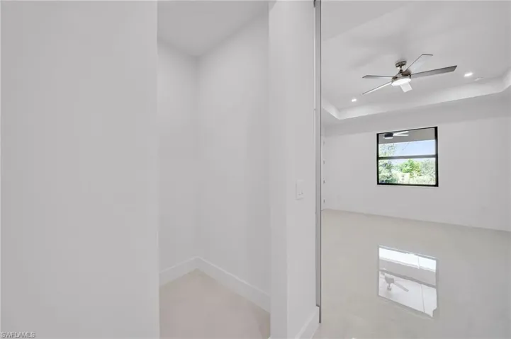 Unfurnished room with recessed lighting, a ceiling fan, and a raised ceiling