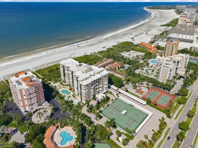 Coastal condominium community featuring direct beach access, outdoor swimming pools, and tennis courts