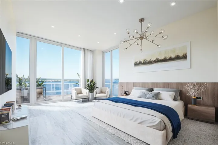 Carpeted bedroom with a water view, expansive windows, access to exterior, and a notable chandelier