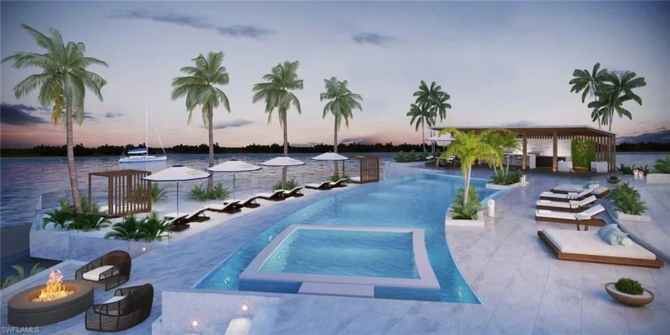 Pool at dusk with a fire pit, an in ground hot tub, a patio, and a water view
