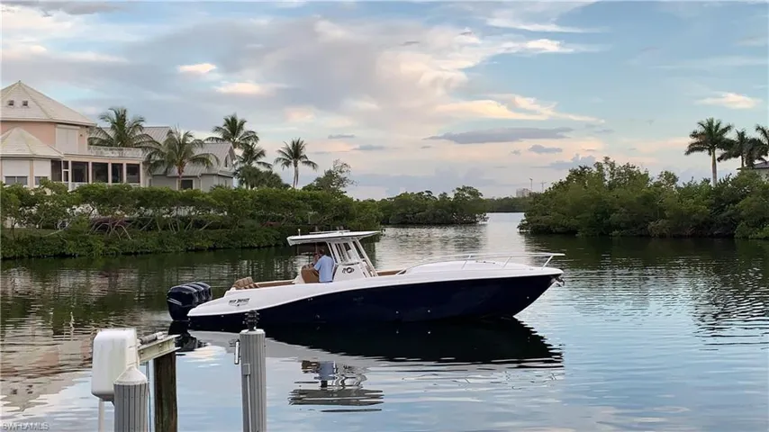 Boat available w/ 40,000lb Lift & Dock area featuring a water view