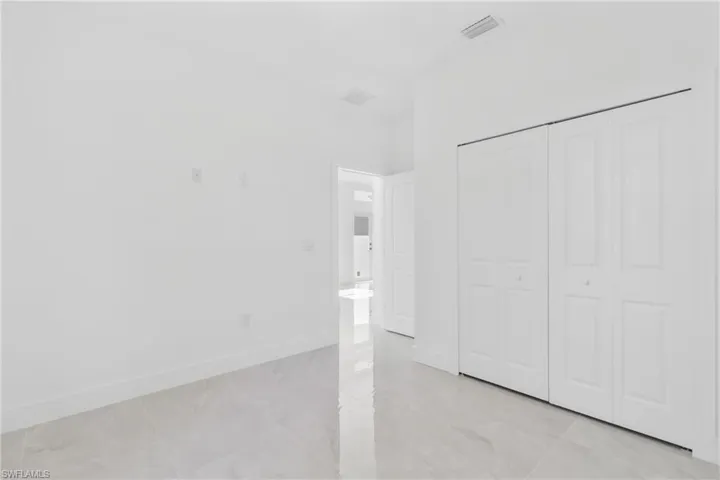 Unfurnished bedroom with baseboards and a closet