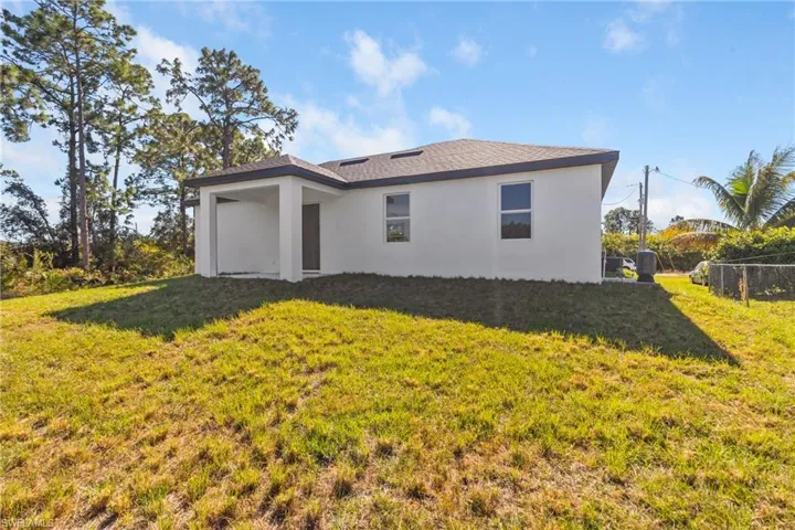 Rear view of house featuring stucco siding