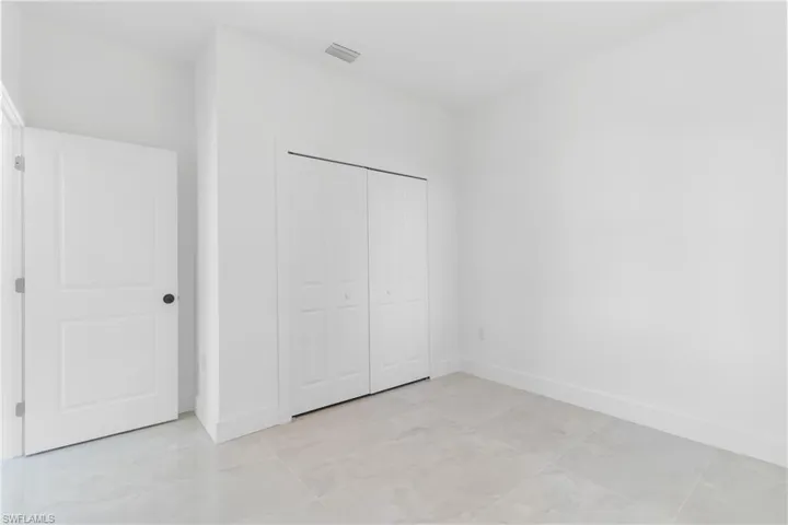 Unfurnished bedroom with baseboards and a closet
