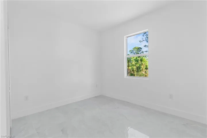 Empty room featuring baseboards