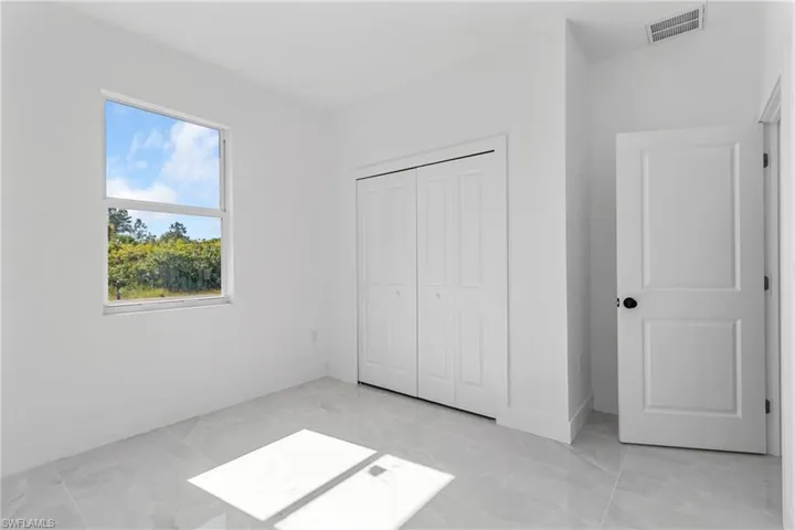Unfurnished bedroom featuring a closet and baseboards