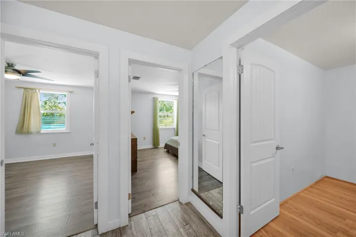Hall ~ Light color floor is the Den, Large Guest Bedroom with bed and Third Bedroom next to guest bathroom