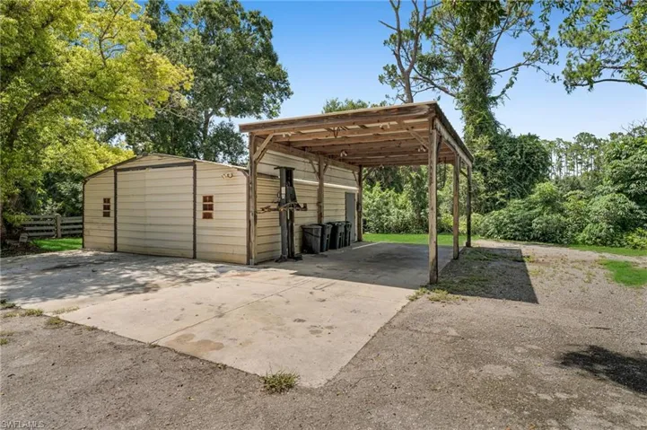 Metal Shed with covered paved parking