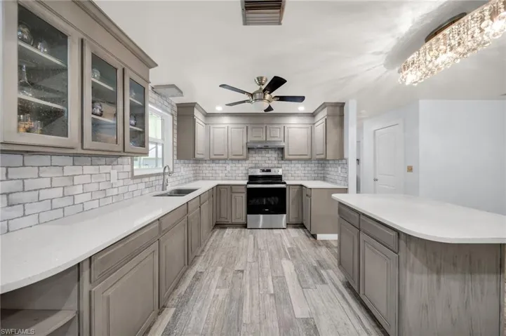 Updated Kitchen with Newer floors, window, cabinets, counters, lighting, appliances