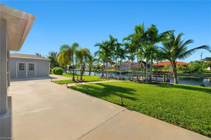 View of yard featuring a patio area and a water view