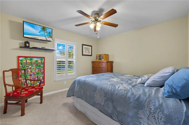 Bedroom featuring light carpet and ceiling fan
