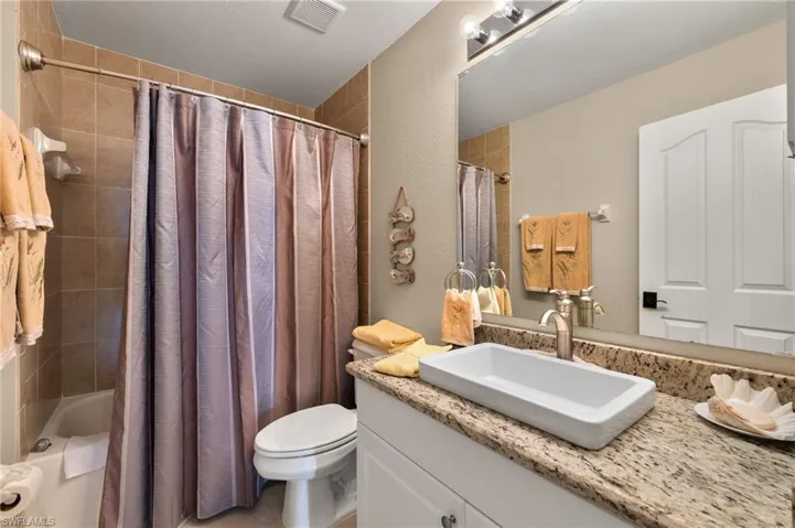 Full bathroom with vanity, toilet, and shower / bath combo