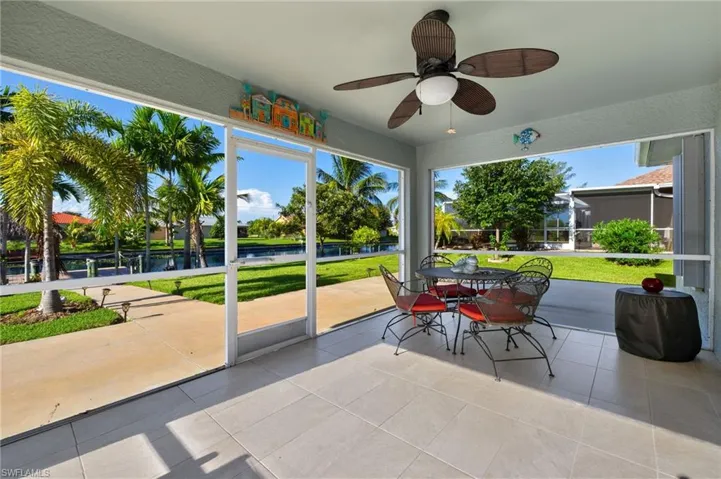 Unfurnished sunroom with plenty of natural light and ceiling fan