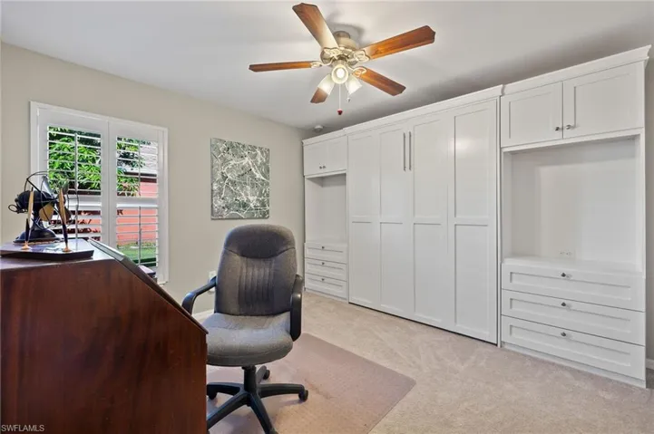 Office featuring light colored carpet and ceiling fan