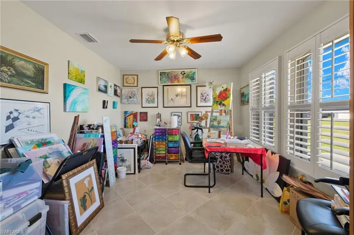 Tiled office featuring ceiling fan