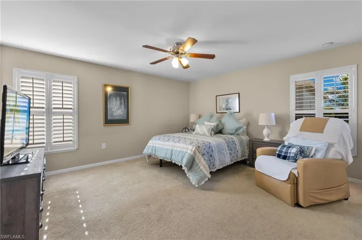 Carpeted bedroom with ceiling fan