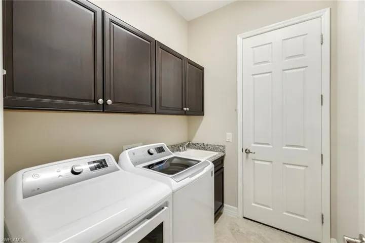 Laundry with storage and laundry sink.