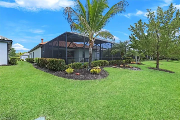 Screened lanai with green space.