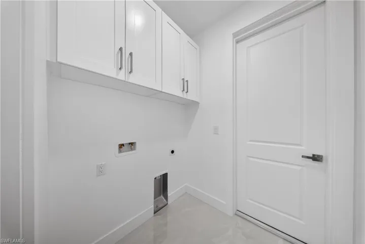 Laundry area featuring cabinet space, hookup for a washing machine, and electric dryer hookup