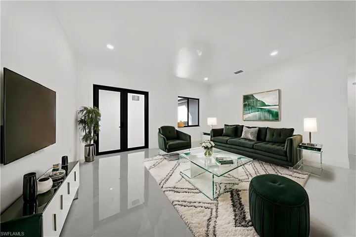 Living area with french doors and recessed lighting