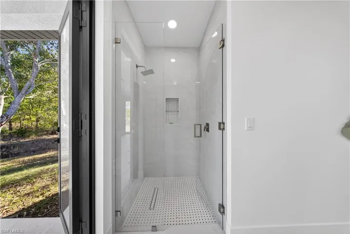 Full bathroom with a shower stall and recessed lighting